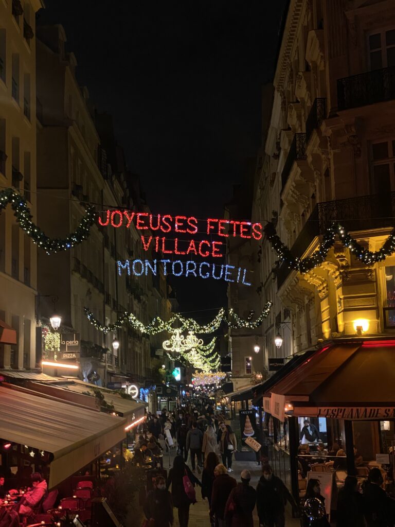 Joyeuses Fêtes lights over Rue Montorgueil in Paris in December
