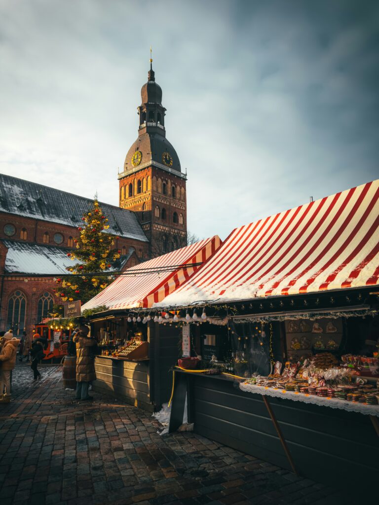 Red and white stalls and the Christmas tree at Riga Dome Square Christmas market